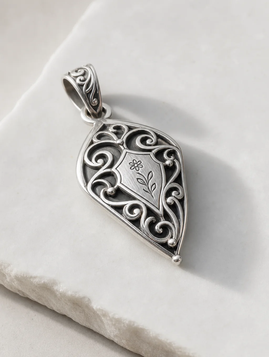 Hand-forged sterling silver pendant on display